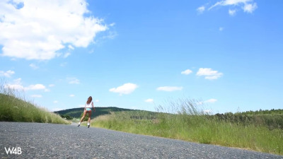 Sabrisse roller skates and poses naked on a green meadow