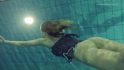 Pretty girl with firm tits shows her hot body underwater