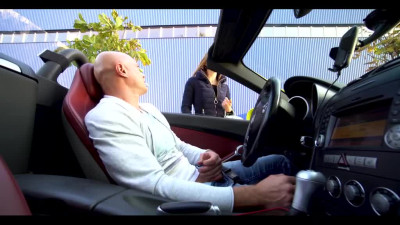 Bald man in a sport car gets a handjob from a hitchhiker